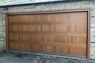 Double Bamford sectional door finished in Golden Oak
